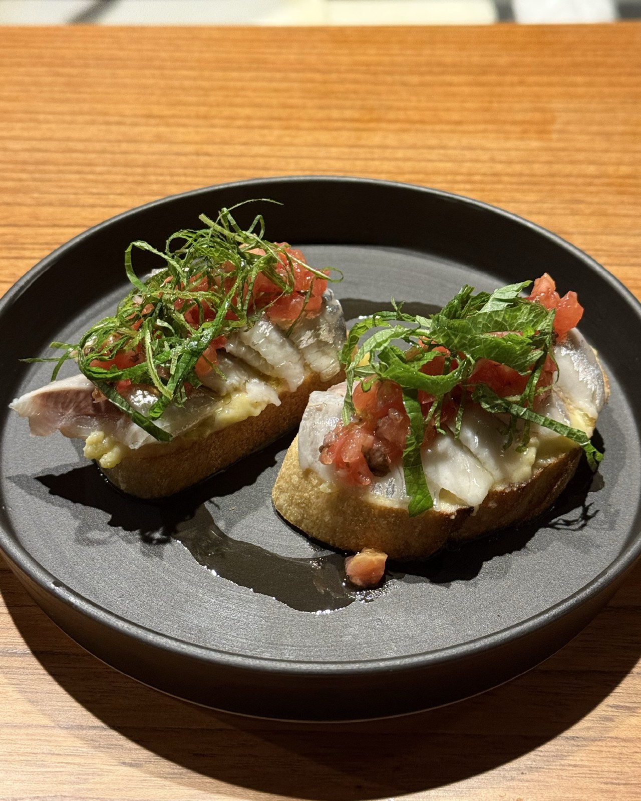 魚とトマト、薬味を彩りよくのせたFORKのバゲット料理
